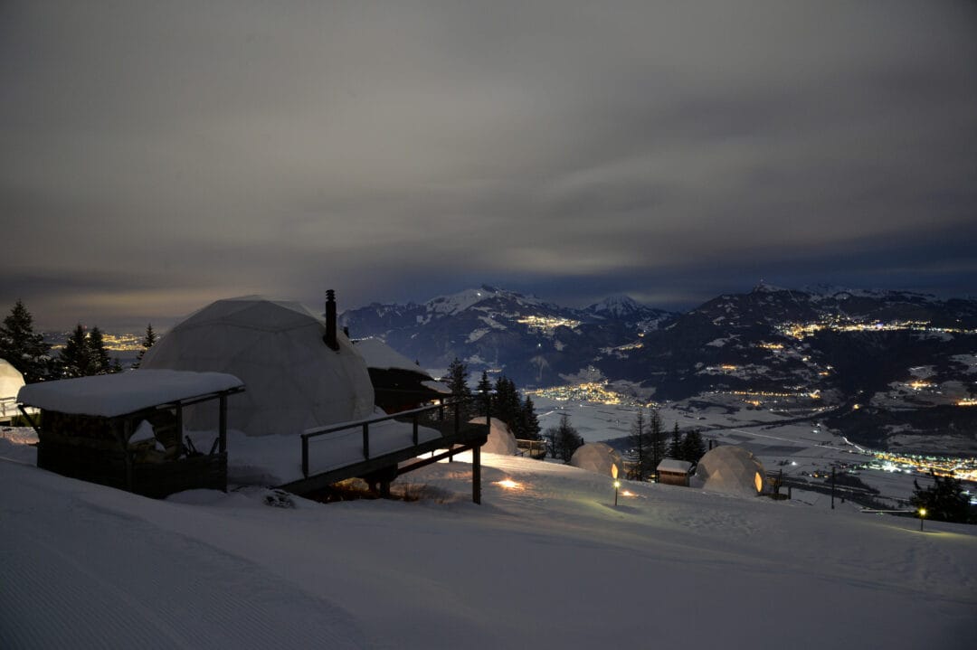 Whitepod Outside with valley view by night